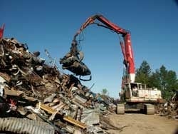 Industrial hydraulic claw grabber at scrap metal recycling yard